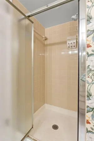 a bathroom with a shower and a bath tub