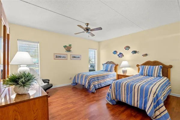 a bedroom with two beds and a potted plant