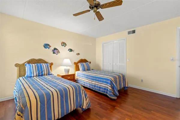 a bedroom with two beds and painting on the wall