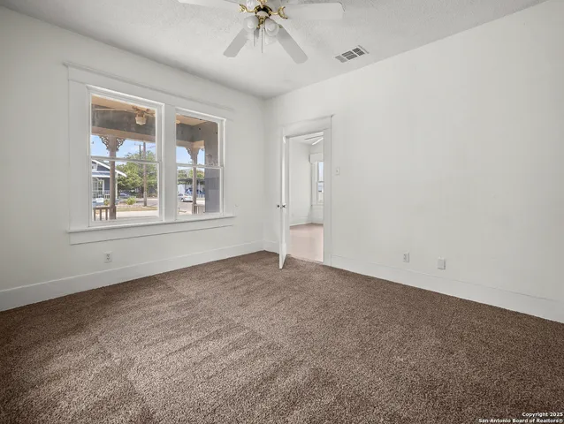 an empty room with windows and closet