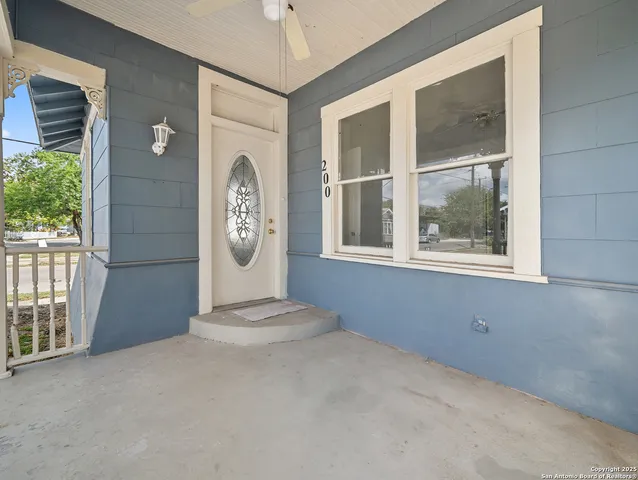 a view of a livingroom with a large window and wooden floor