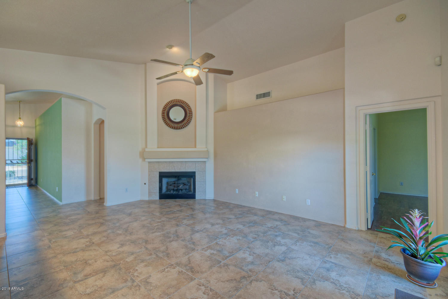 124 West Grandview Road Phoenix, AZ 85023 - Photo 6 of 21 an empty room with a fireplace and a chandelier fan