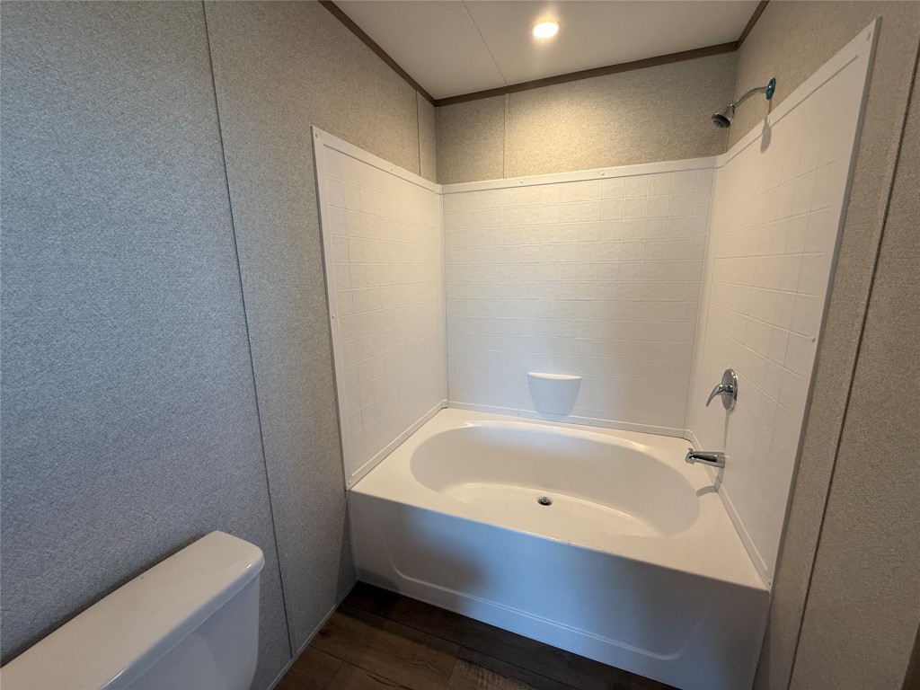 175 Altidore Avenue Dale, TX 78616 - Photo 13 of 21 a bathroom with a bathtub and a toilet