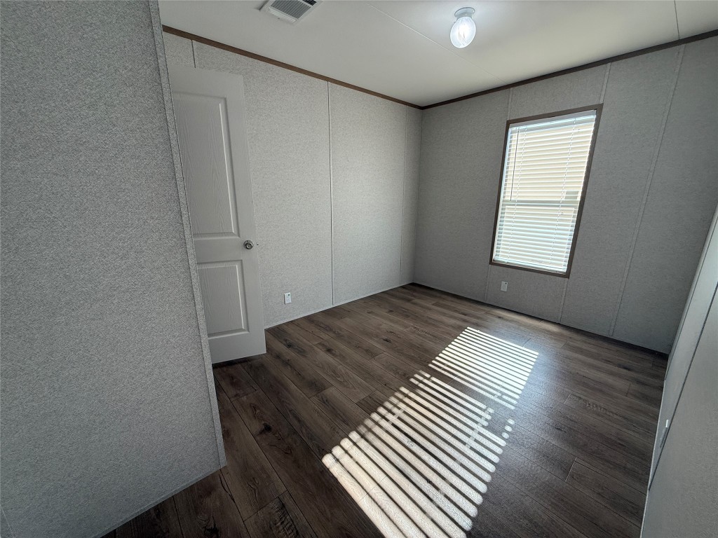 175 Altidore Avenue Dale, TX 78616 - Photo 14 of 21 an empty room with wooden floor and windows