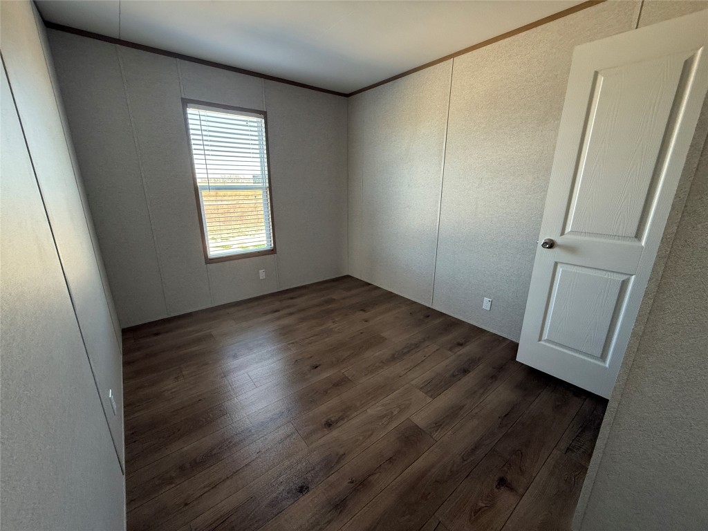 175 Altidore Avenue Dale, TX 78616 - Photo 15 of 21 an empty room with wooden floor and window