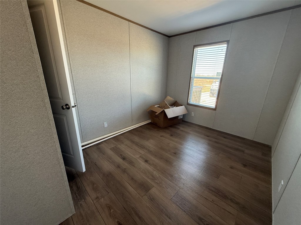 175 Altidore Avenue Dale, TX 78616 - Photo 17 of 21 an empty room with wooden floor and a window
