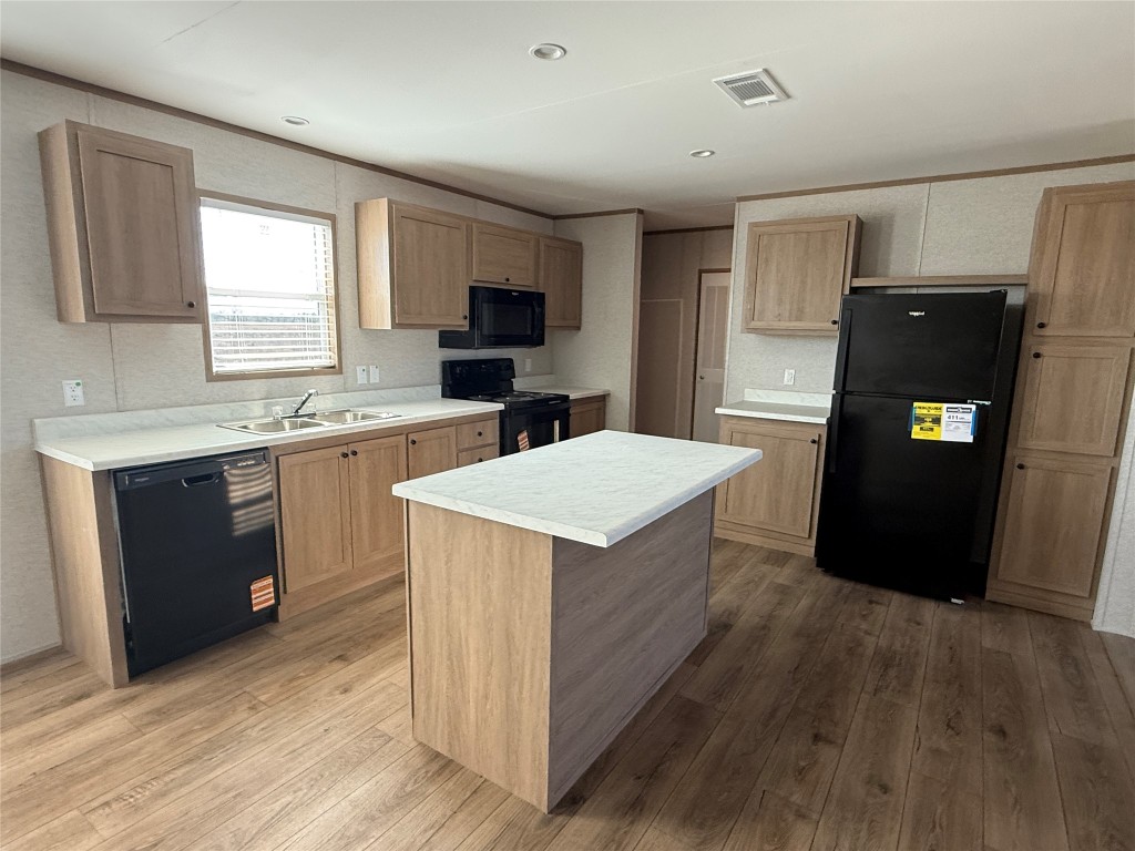 175 Altidore Avenue Dale, TX 78616 - Photo 4 of 21 a kitchen with a stove a refrigerator and a sink