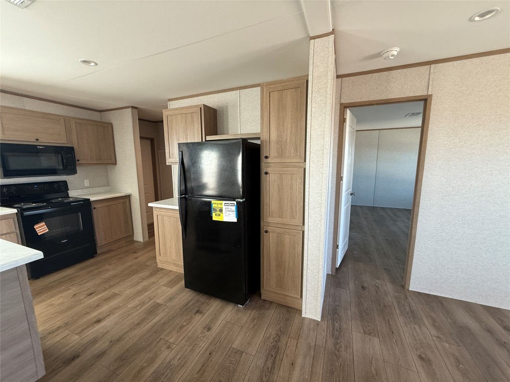 175 Altidore Avenue Dale, TX 78616 - Photo 5 of 21 a kitchen with a refrigerator and a stove top oven