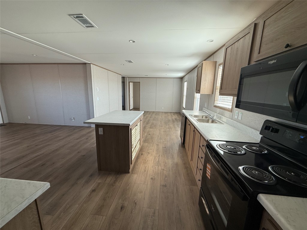 175 Altidore Avenue Dale, TX 78616 - Photo 19 of 21 a kitchen with a stove and a microwave