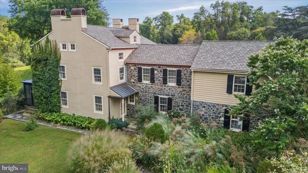 an aerial view of a house with a yard