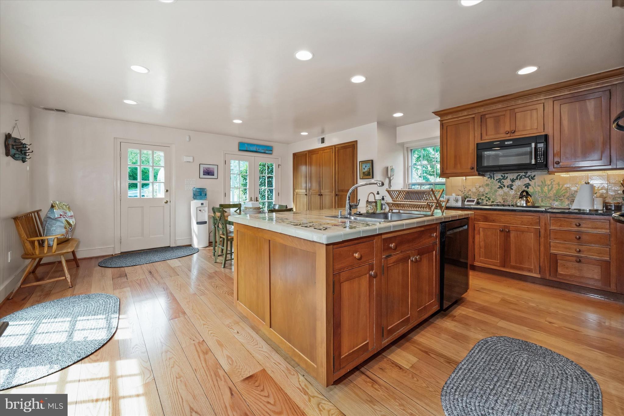 818 Burrows Run Road Chadds Ford, PA 19317 - Photo 16 of 90 a kitchen with stainless steel appliances granite countertop wooden cabinets a sink a stove a dining table and chairs