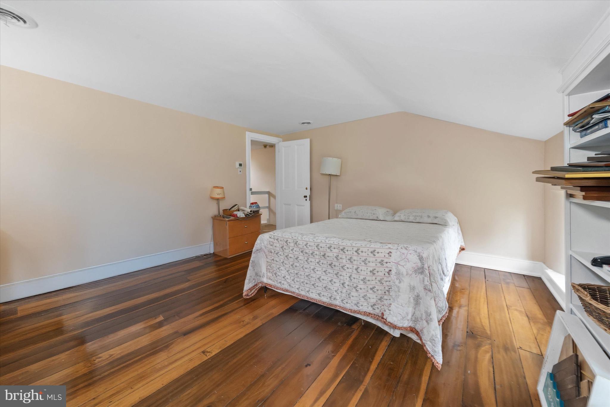 818 Burrows Run Road Chadds Ford, PA 19317 - Photo 37 of 90 a bedroom with a bed and wooden floor
