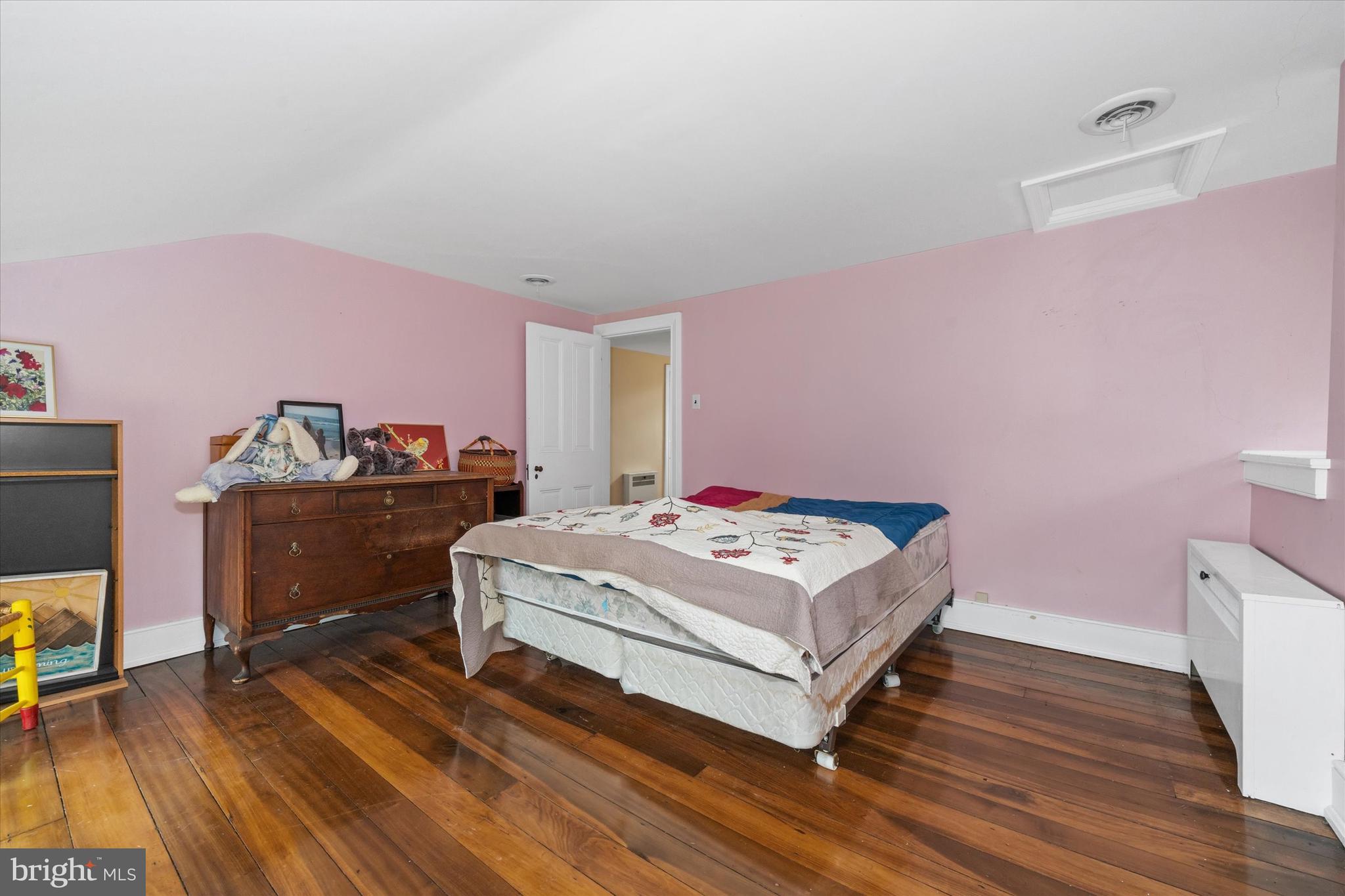 818 Burrows Run Road Chadds Ford, PA 19317 - Photo 39 of 90 a room with a bed and a wooden floor