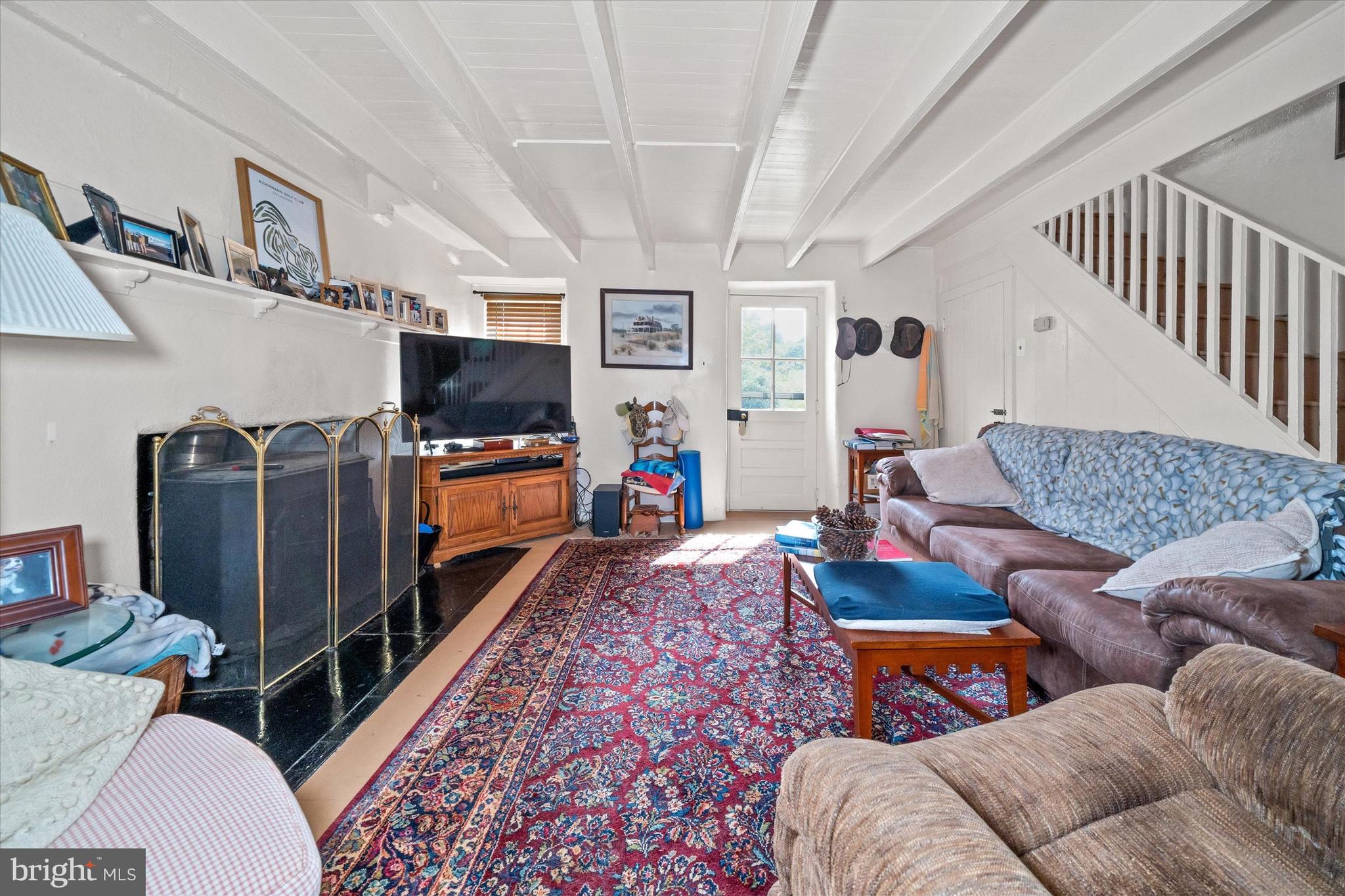 818 Burrows Run Road Chadds Ford, PA 19317 - Photo 61 of 90 a living room with furniture and a flat screen tv
