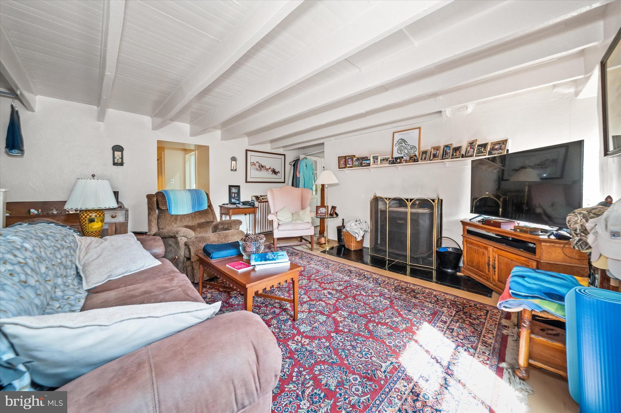 818 Burrows Run Road Chadds Ford, PA 19317 - Photo 62 of 90 a living room with furniture a flat screen tv and a fireplace