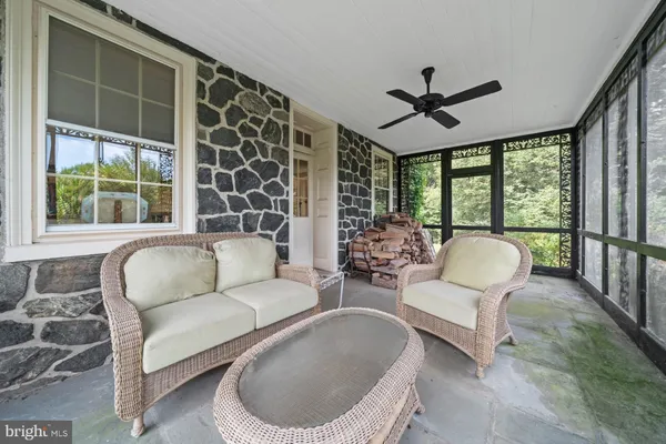 a kitchen with stainless steel appliances granite countertop wooden cabinets a sink a stove a dining table and chairs