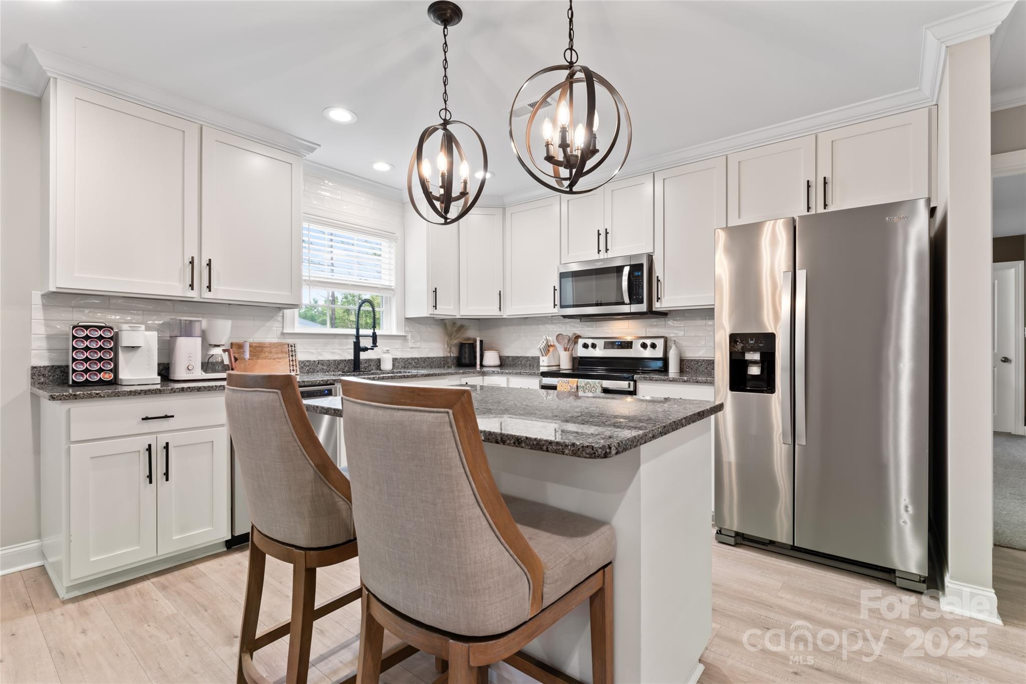 4008 Cypress Circle Lancaster, SC 29720 - Photo 13 of 33 a kitchen with stainless steel appliances kitchen island a table chairs and cabinets