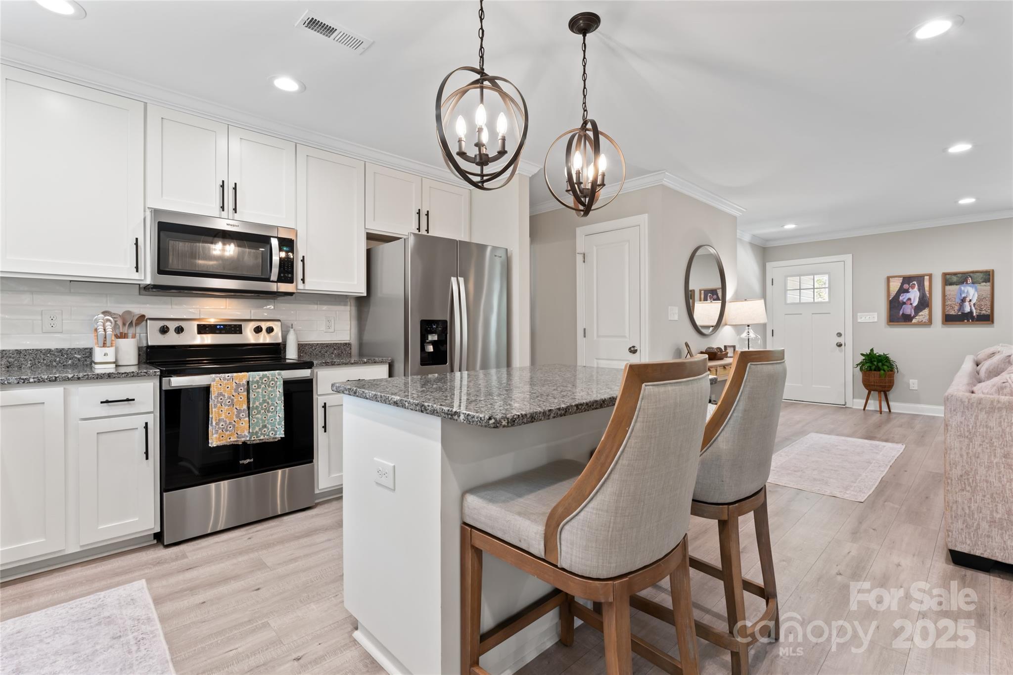 4008 Cypress Circle Lancaster, SC 29720 - Photo 14 of 33 a large kitchen with stainless steel appliances granite countertop a dining table chairs refrigerator and cabinets