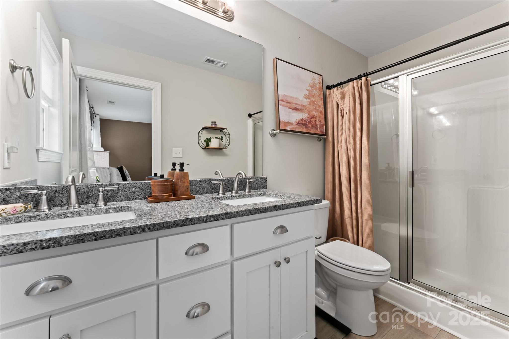 4008 Cypress Circle Lancaster, SC 29720 - Photo 21 of 33 a bathroom with a granite countertop sink toilet a mirror a vanity and shower