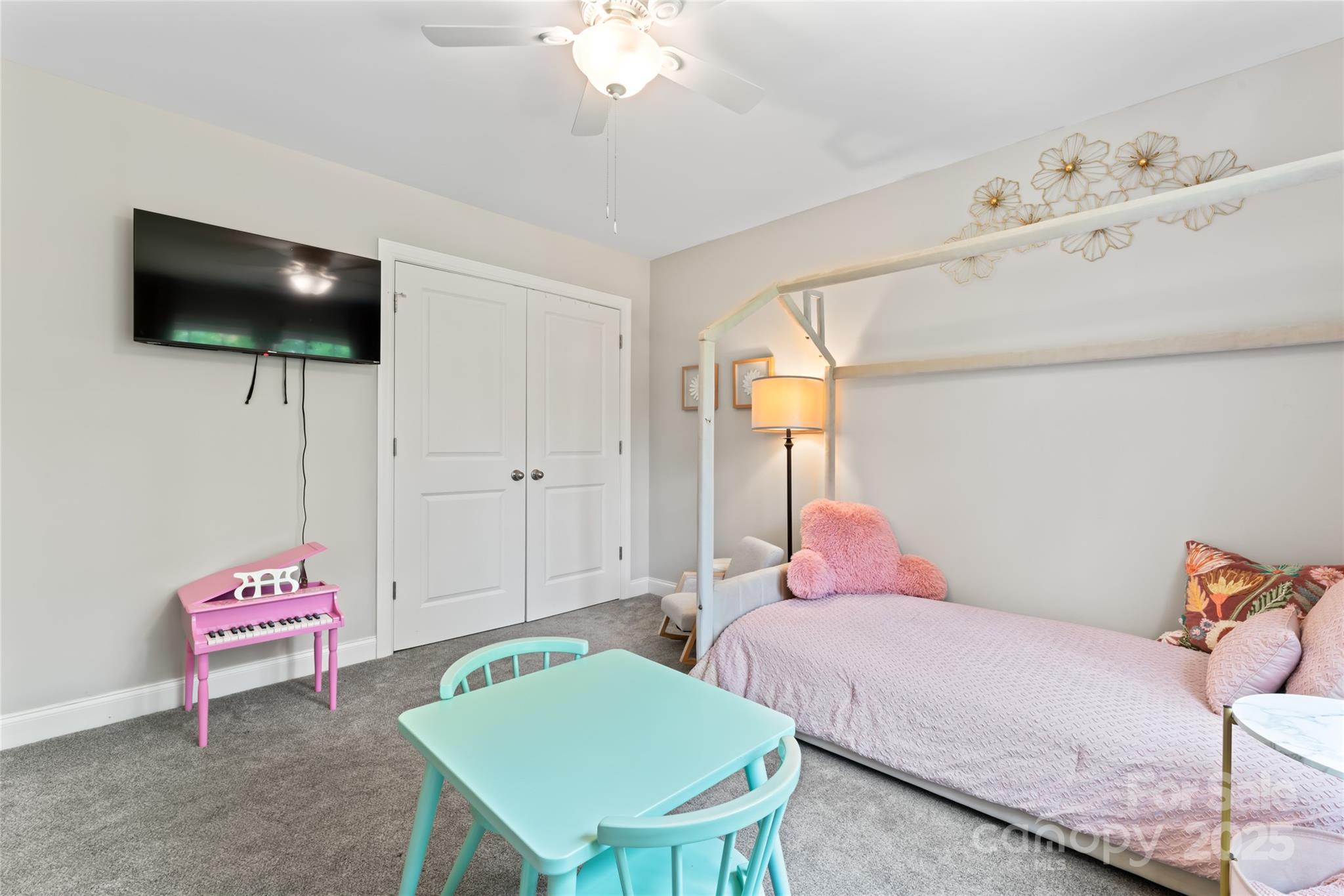 4008 Cypress Circle Lancaster, SC 29720 - Photo 23 of 33 a bedroom with a bed a chandelier and a flat screen tv