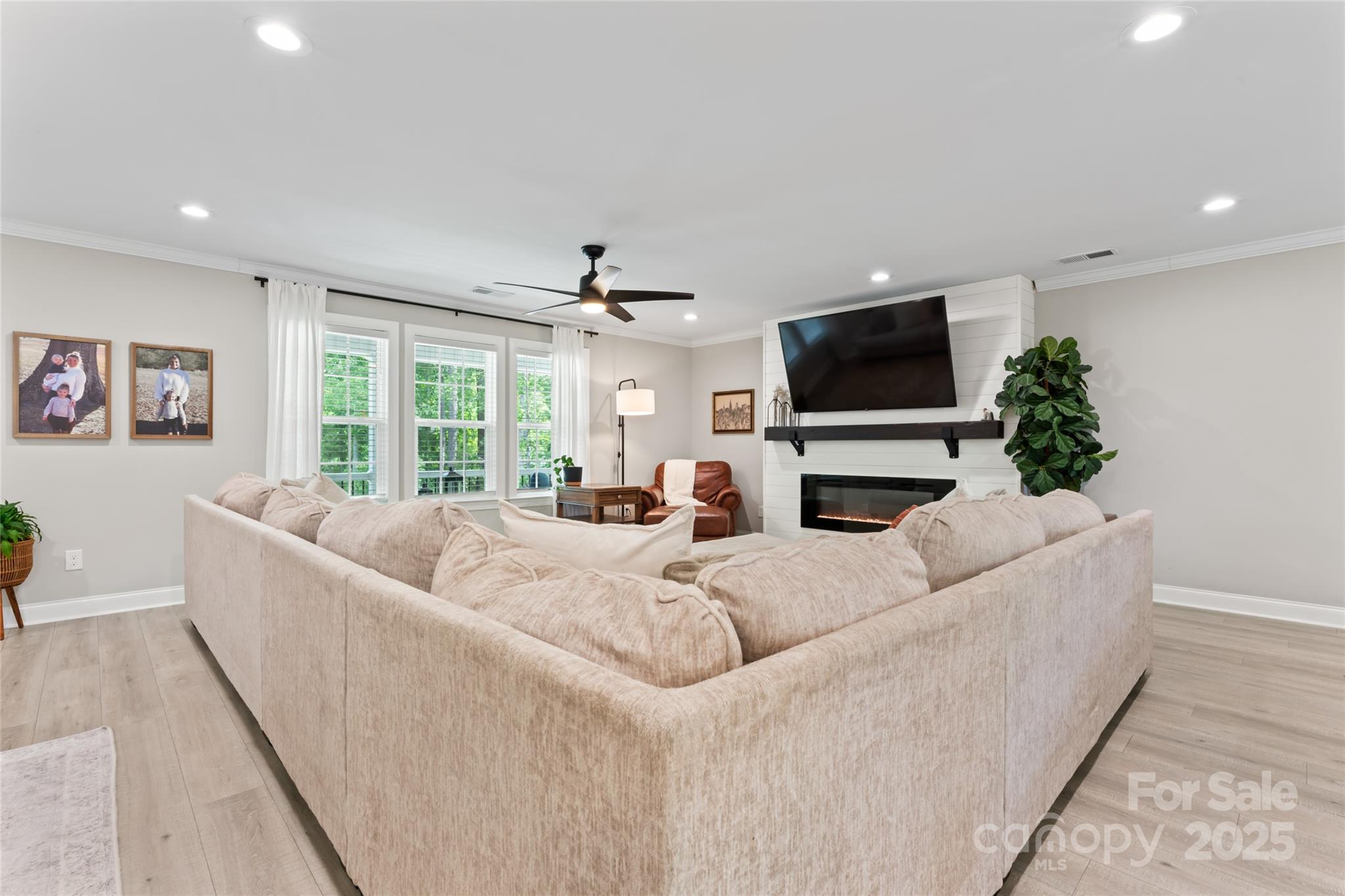 4008 Cypress Circle Lancaster, SC 29720 - Photo 6 of 33 a living room with furniture a flat screen tv and a fireplace