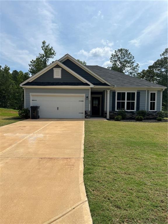 300 Tarpley Way Covington, GA 30016 - Photo 1 of 1 a front view of house with yard and trees
