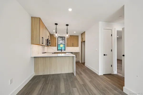 a view of kitchen with sink and wooden floor