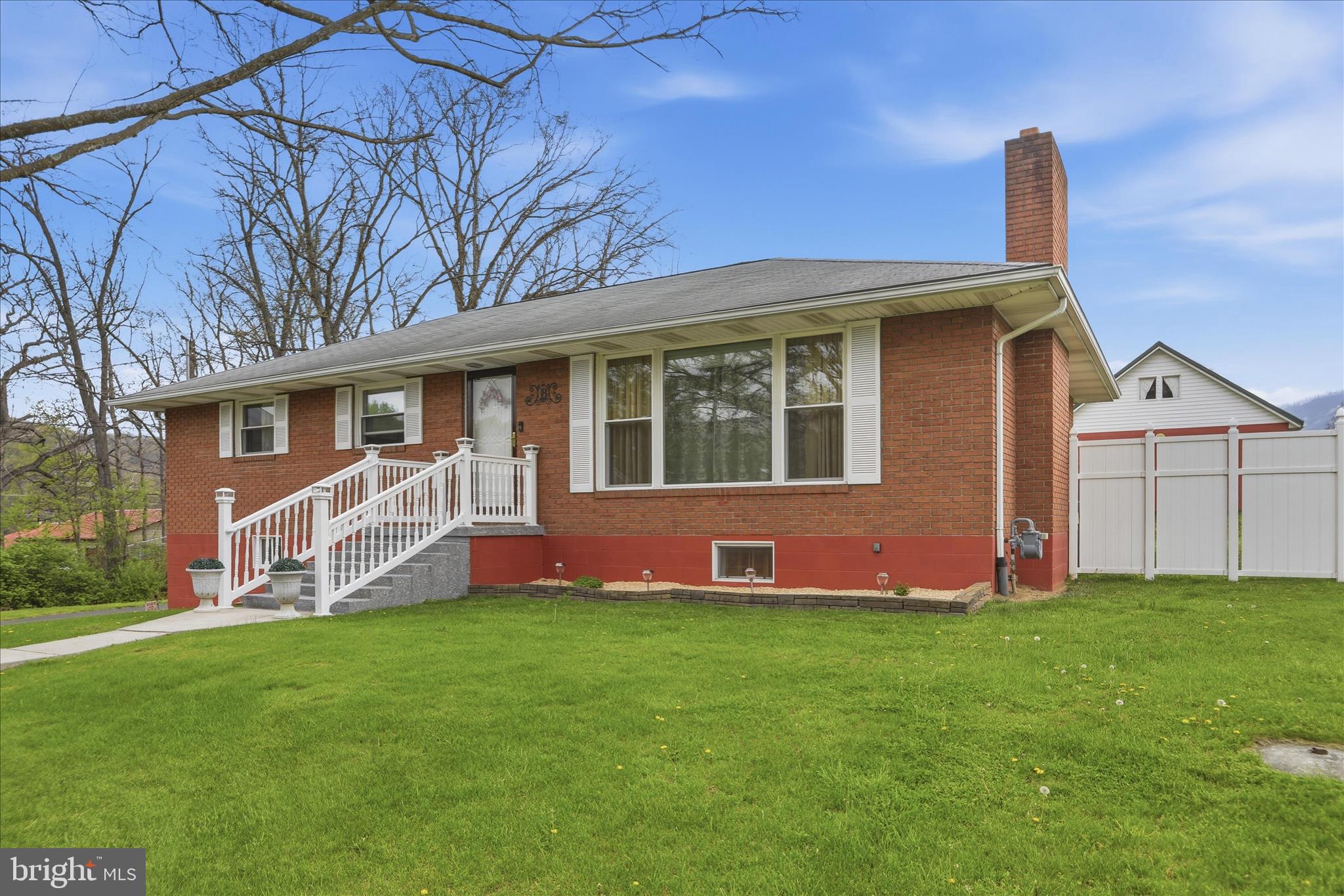 14704 Main Street Cresaptown, MD 21502 - Photo 4 of 58 a front view of a house with a yard and porch