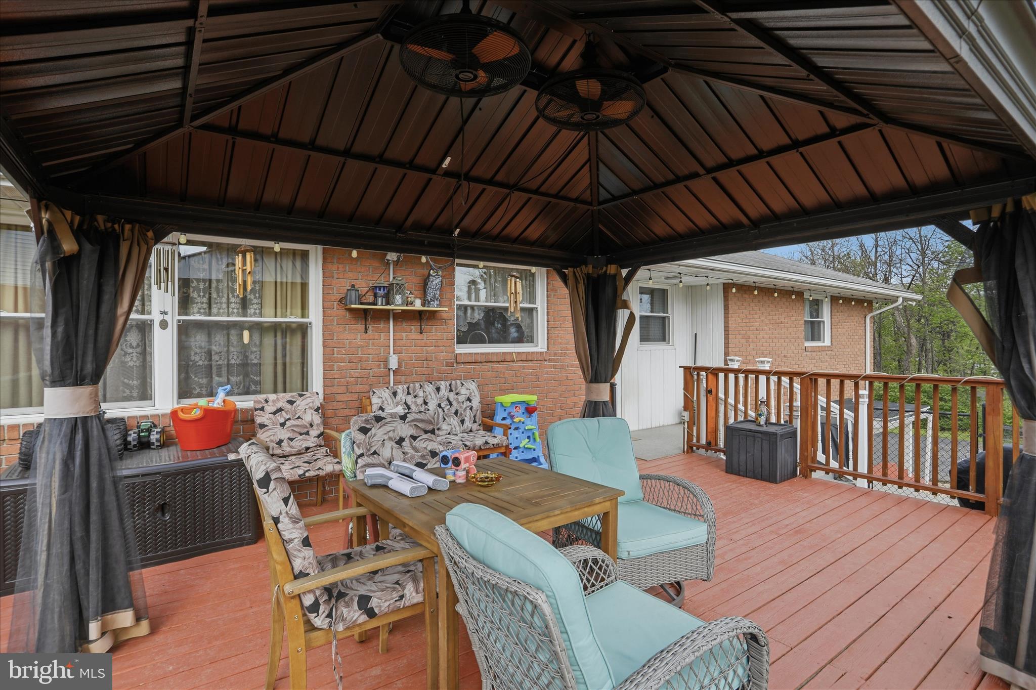 14704 Main Street Cresaptown, MD 21502 - Photo 42 of 58 a patio with wooden floor a yard a table and chairs