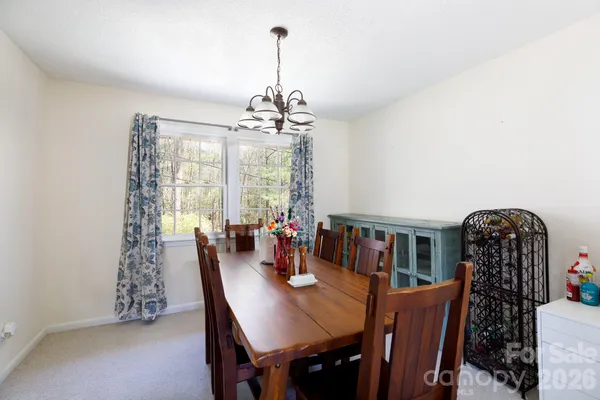 a view of a dining room with furniture wooden floor and chandelier