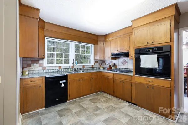 a kitchen with stainless steel appliances a refrigerator and a stove top oven