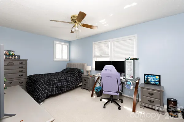 a bedroom with a bed and flat screen tv
