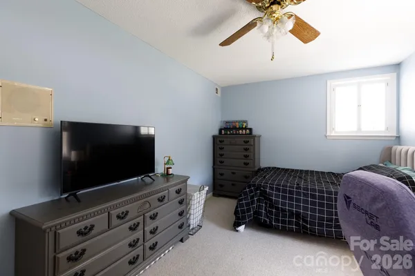 a bedroom with a bed and window