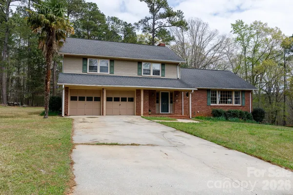 front view of a brick house with a yard