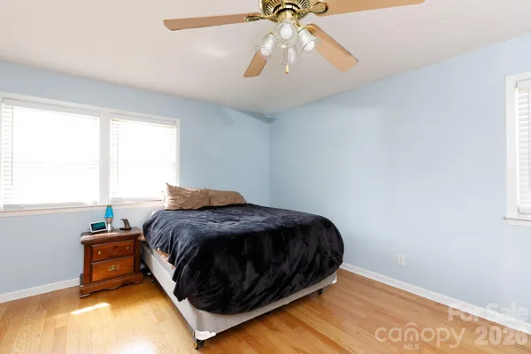 a spacious bedroom with a bed and a chandelier