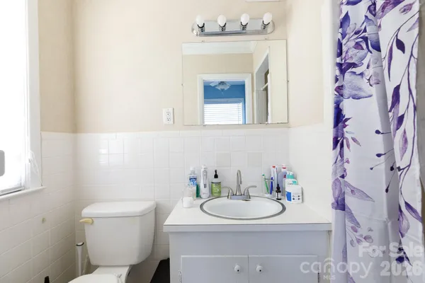 a bathroom with a sink toilet and mirror
