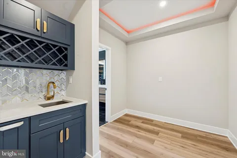 a view of a sink and dishwasher with wooden floor