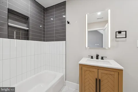 a bathroom with a bathtub and a sink