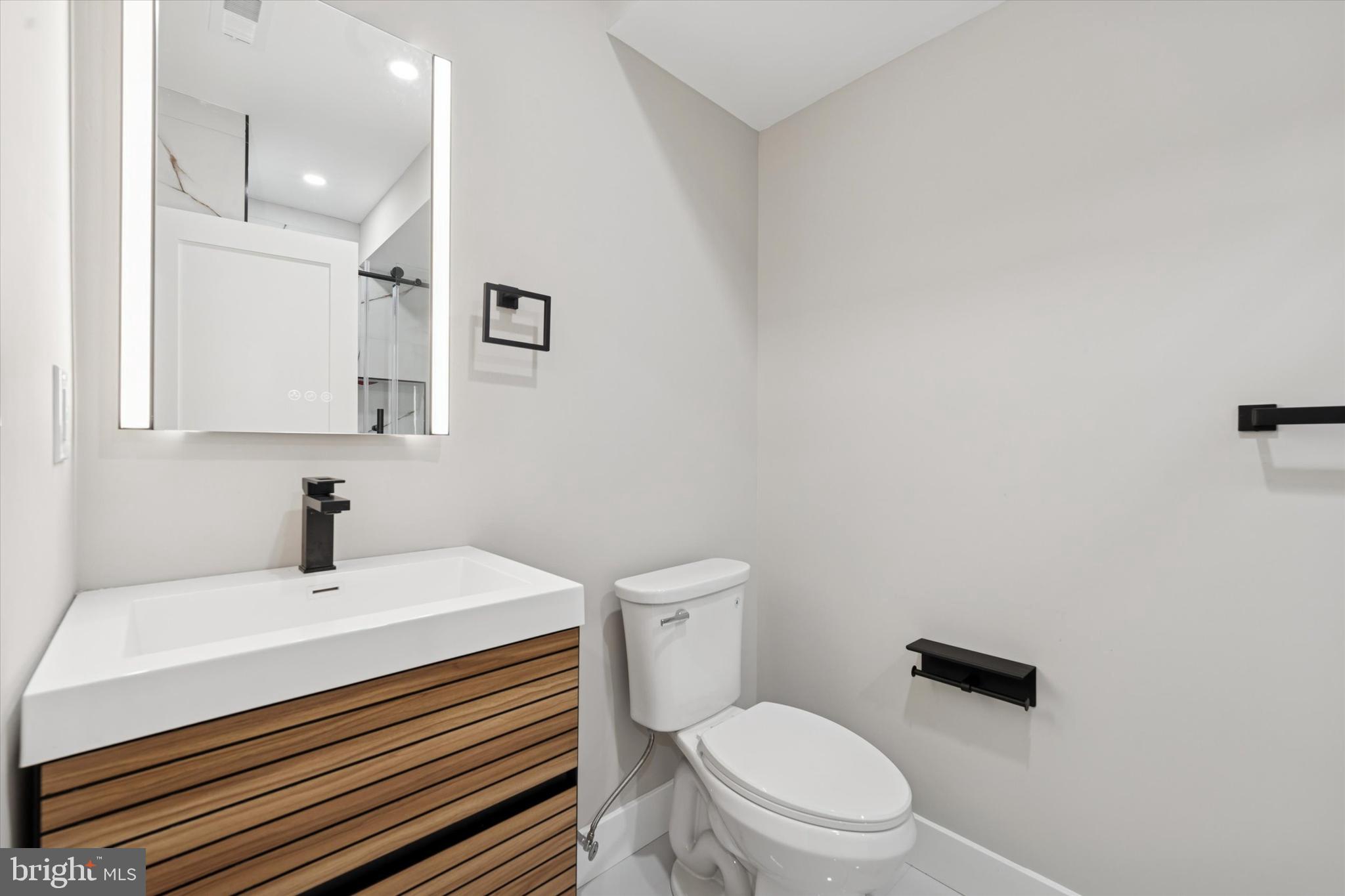 1203 South 18th Street Philadelphia, PA 19146 - Photo 23 of 25 a bathroom with a sink a toilet and mirror