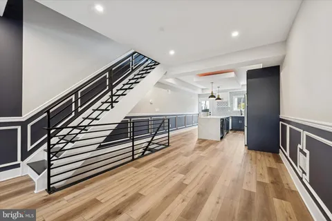 a view of entryway and hall with wooden floor