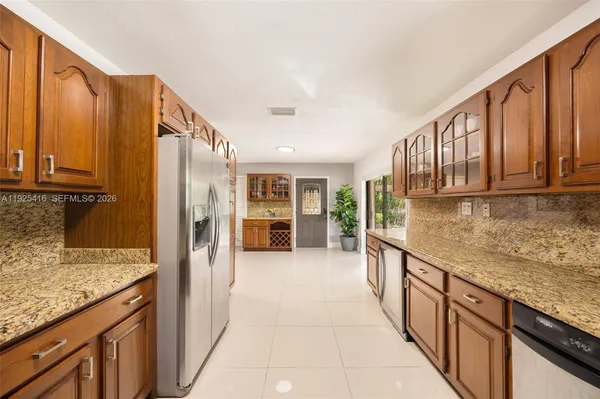 a kitchen with counter top space and living room