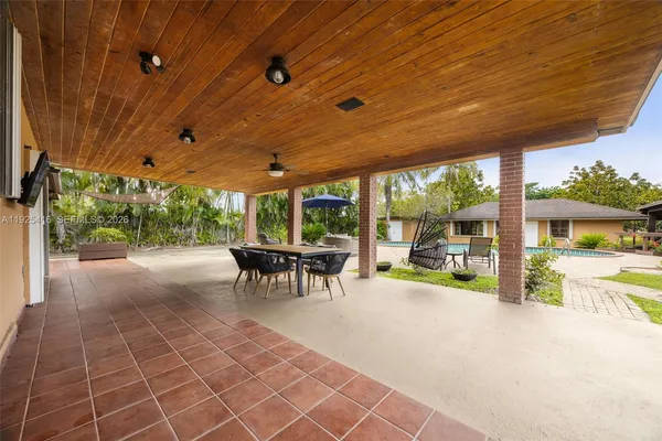 a view of a house with swimming pool and a yard
