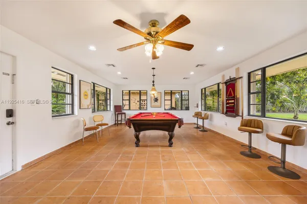 a view of a patio with table and chairs and wooden floor