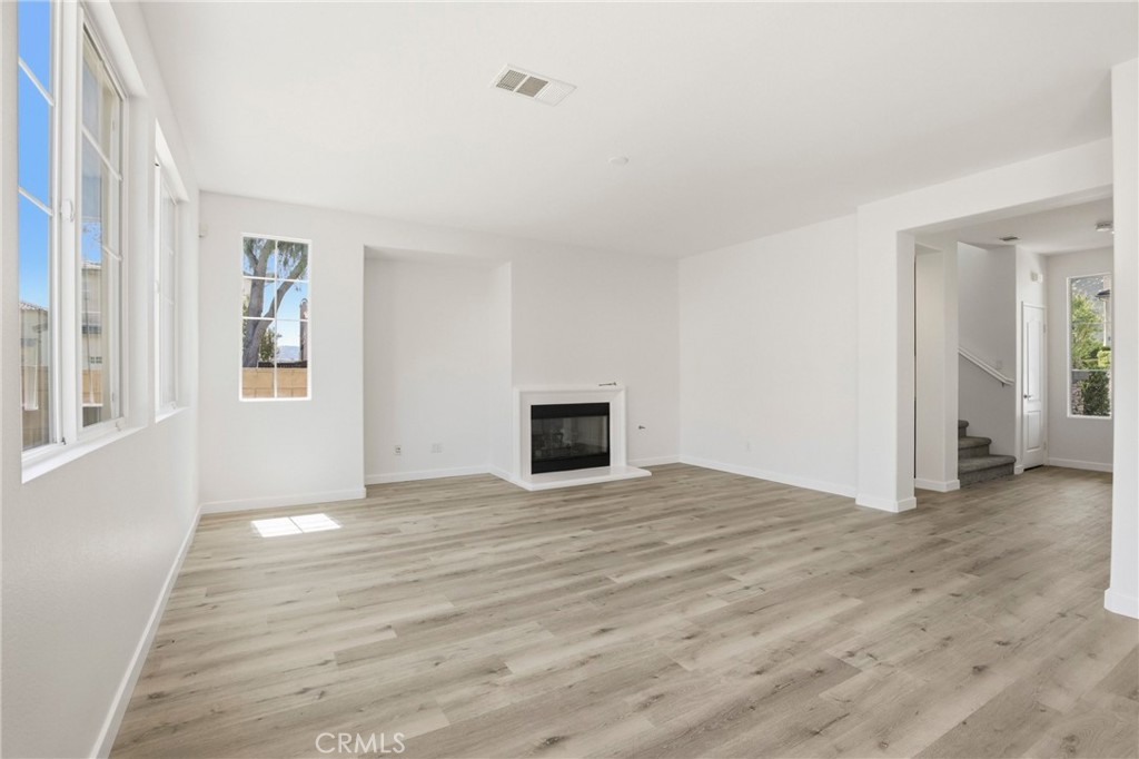 31598 Six Rivers Court Temecula, CA 92592 - Photo 14 of 43 a view of an empty room with window and wooden floor