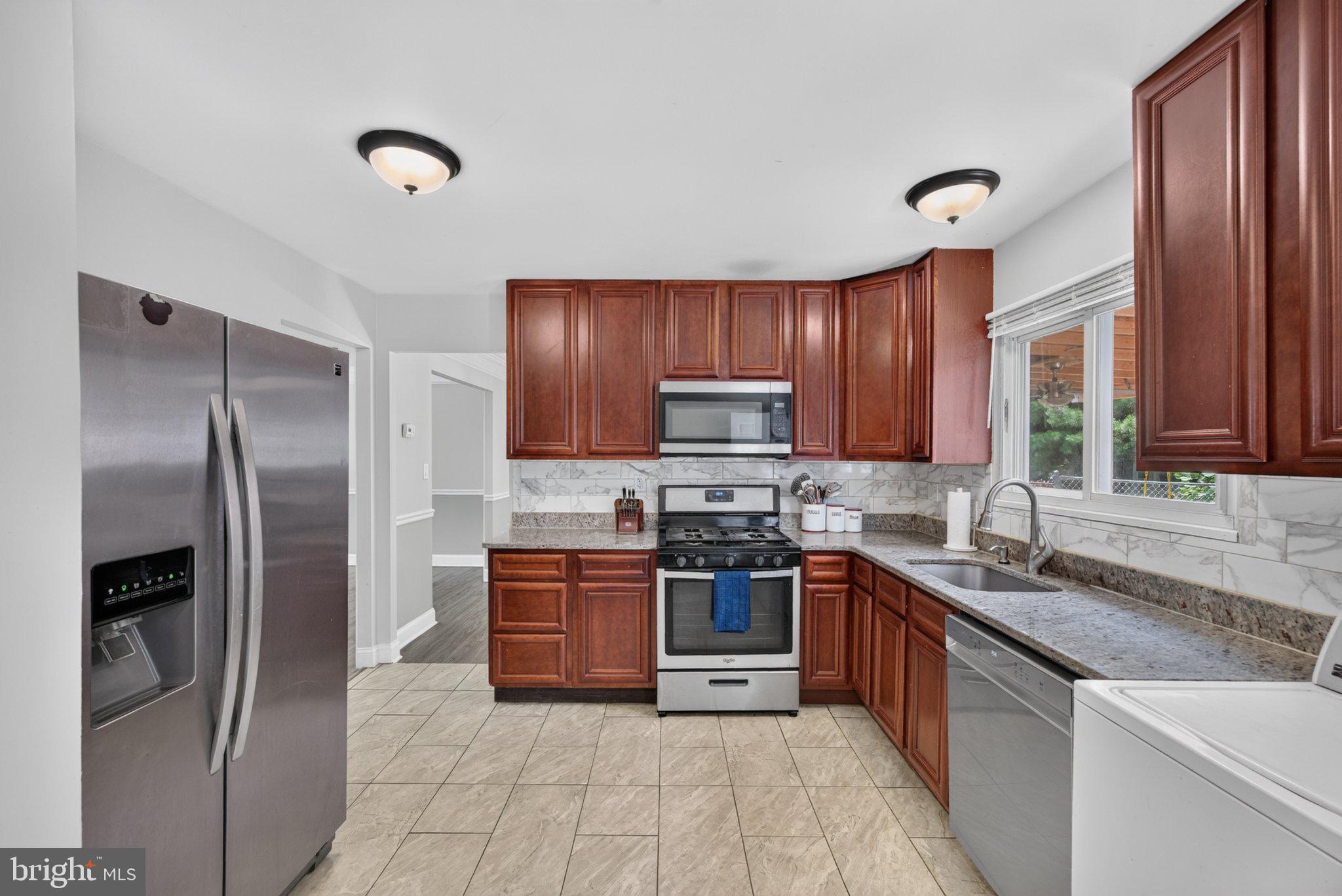 2106 North Rolling Road Windsor Mill, MD 21244 - Photo 7 of 24 Modern kitchen with rich wood tones.