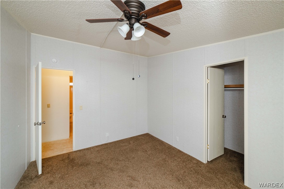 3003 Hualapai Mountain Road Kingman, AZ 86401 - Photo 25 of 49 an empty room with closet and a chandelier fan