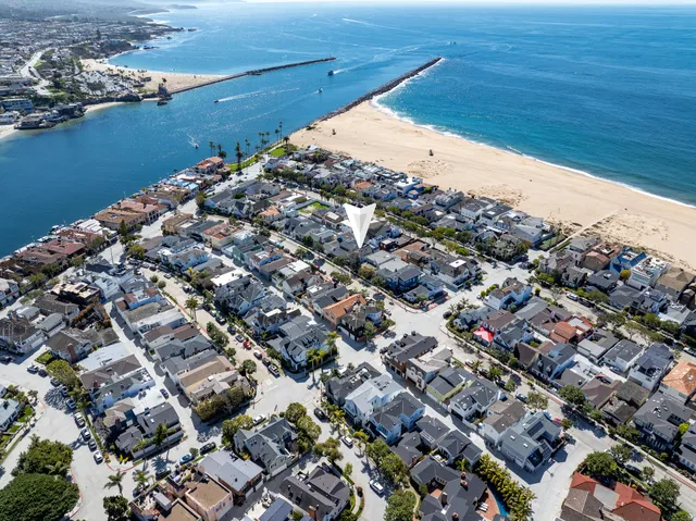 an aerial view of a residential houses with ocean view