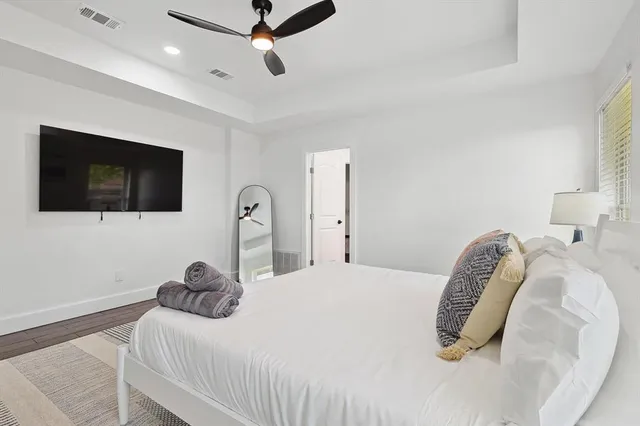 a bedroom with a bed and painting on the wall