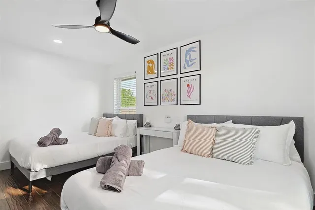 a bedroom with a bed a couch and potted plant on the counter