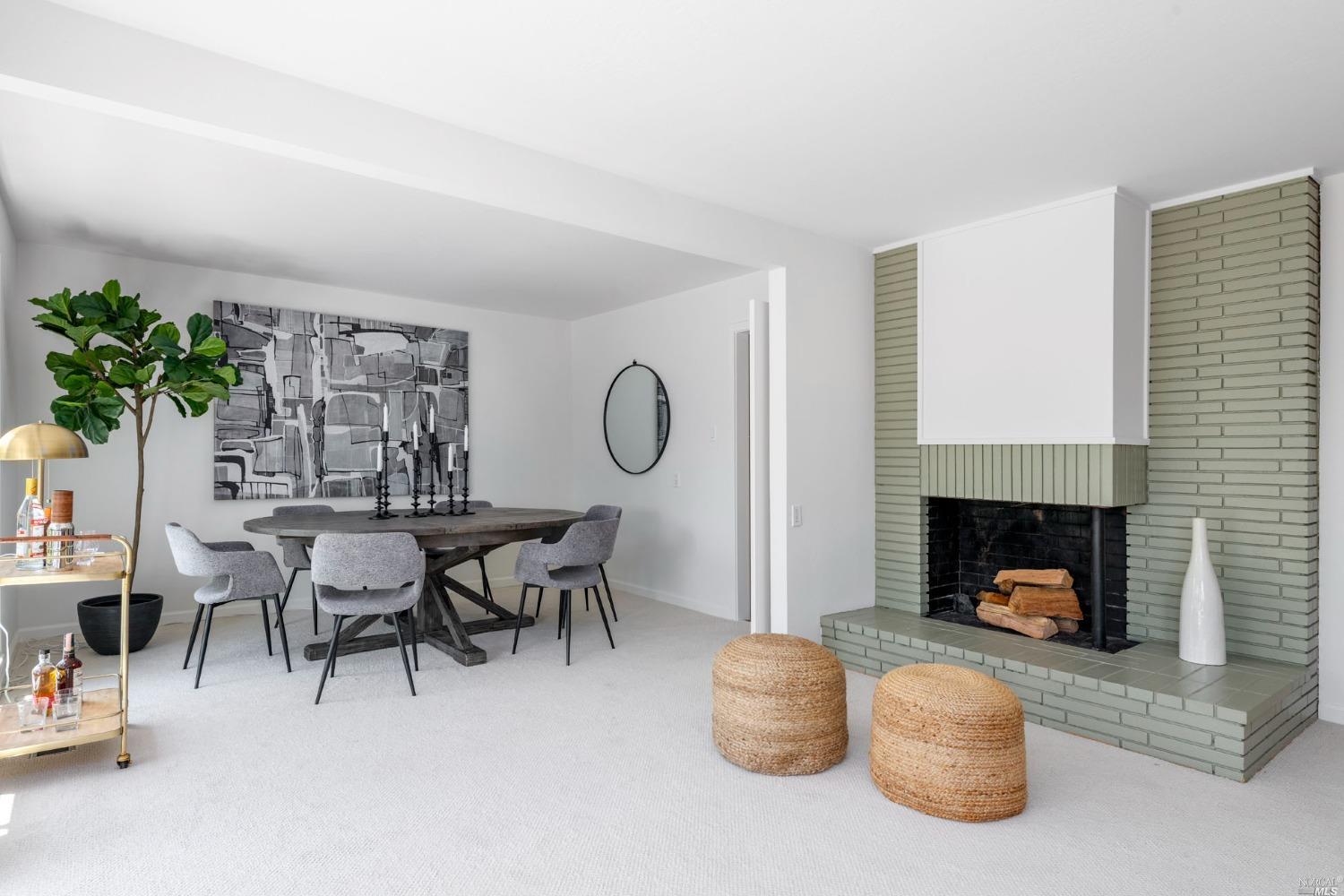 16 Loma Linda Road San Rafael, CA 94901 - Photo 11 of 46 a living room with furniture a fireplace and a potted plant